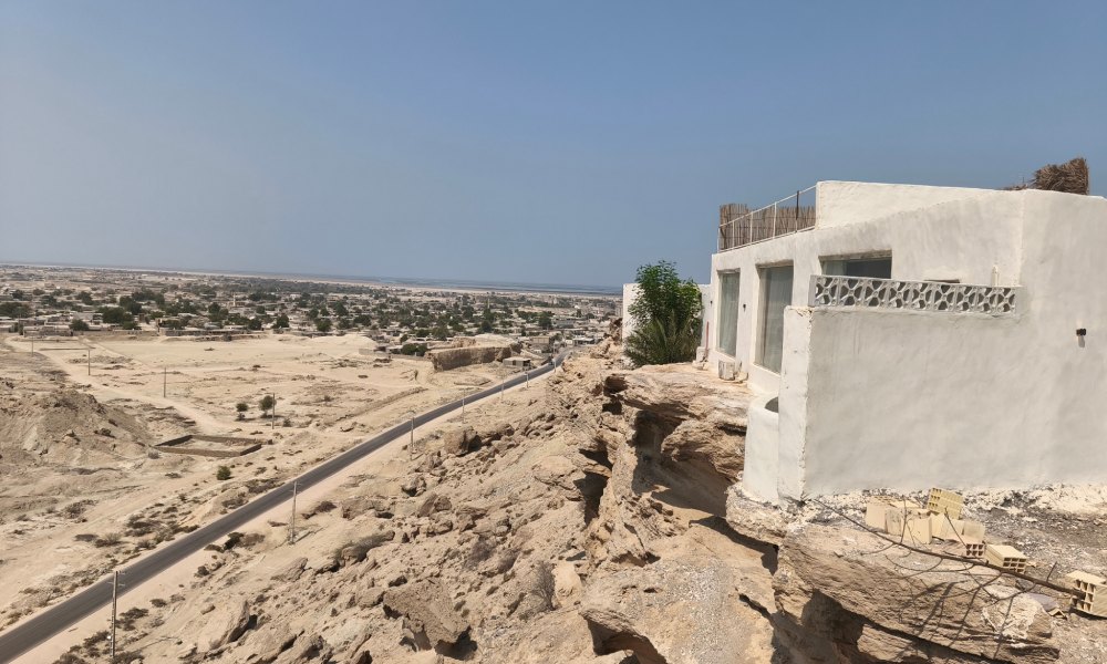 ساختمان سفید یک طبقه در ارتفاع با منظره شهر جنوبی قشم