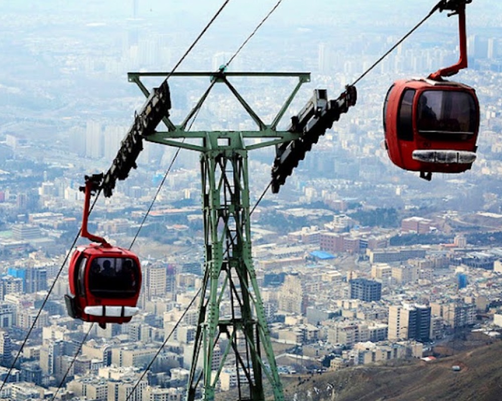 a-view-of-two-cable-car-cabins-with-the-city-of-tehran-in-the-background