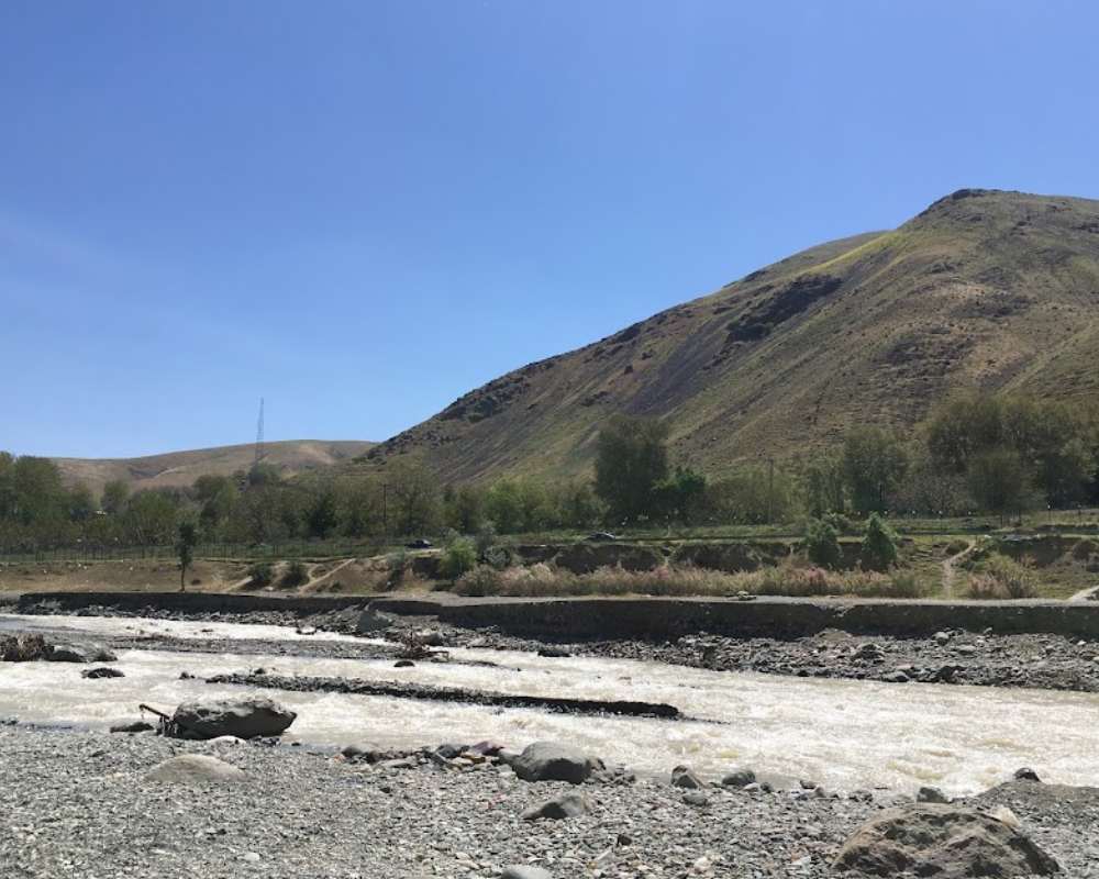 1bd83bf7-743a-40e1-bd1e-fc9c709cf653-close-up-of-water-in-kordan-river-with-mountains-and-sky-in-the-background.jpg